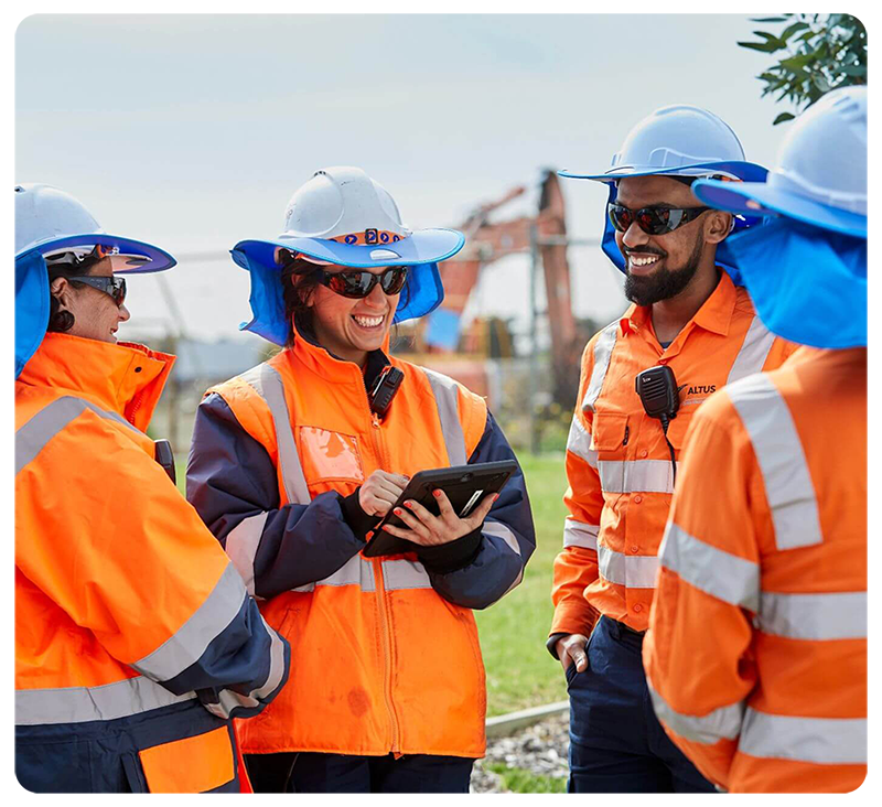 A team of workers in orange high vis and hard hats