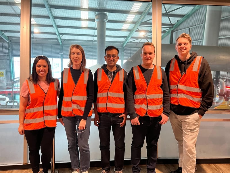 foundU Marketing team in orange vests standing together smiling