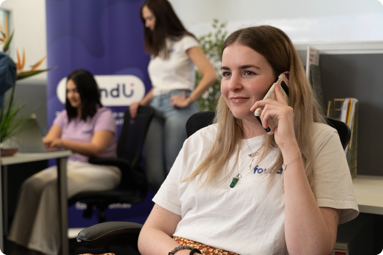 Woman on phone smiling and giving HR advice