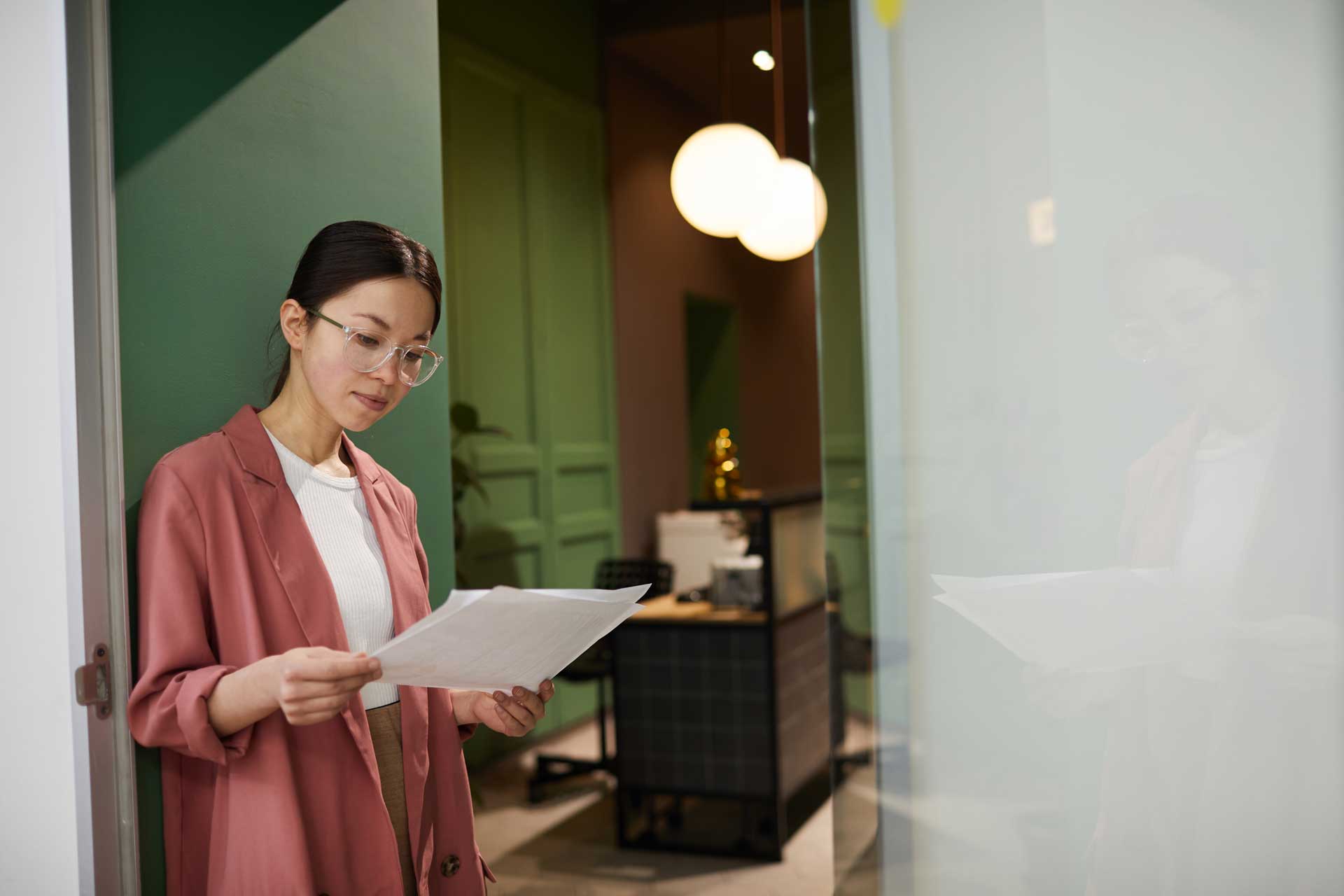 girl reading paper in office