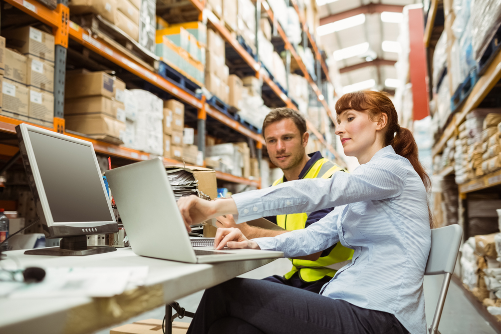 Employer and employee on laptop reviewing time and attendance software